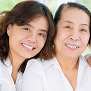 Mother and daughter smiling