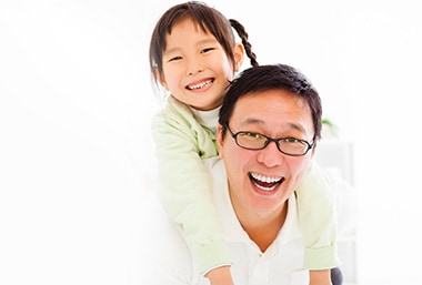 Dad carrying her daughter smiling