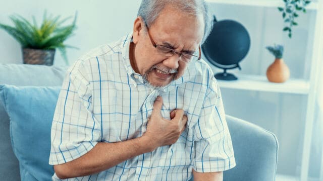 Elderly man experiencing heart attack