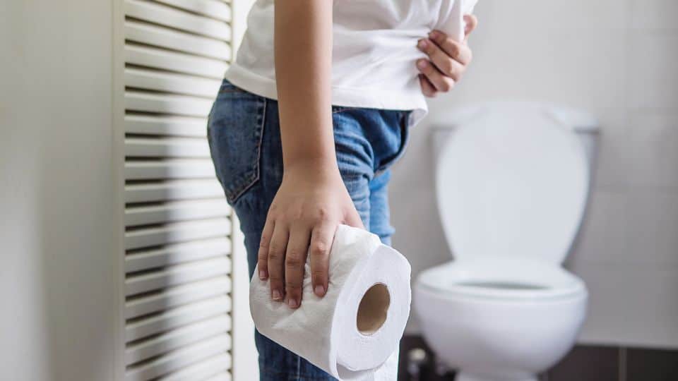 asian-boy-sitting-toilet-bowl-holding-tissue-paper-health-problem-concept