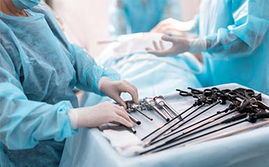 specialists preparing laparoscopic instruments for surgery