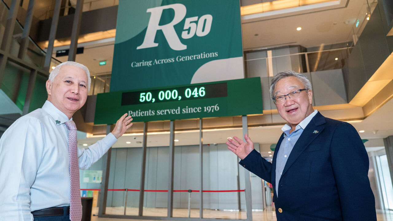 Dr Loo and Dr Loh Founders of Raffles Medical Group standing before the 50 million patient countdown milestone