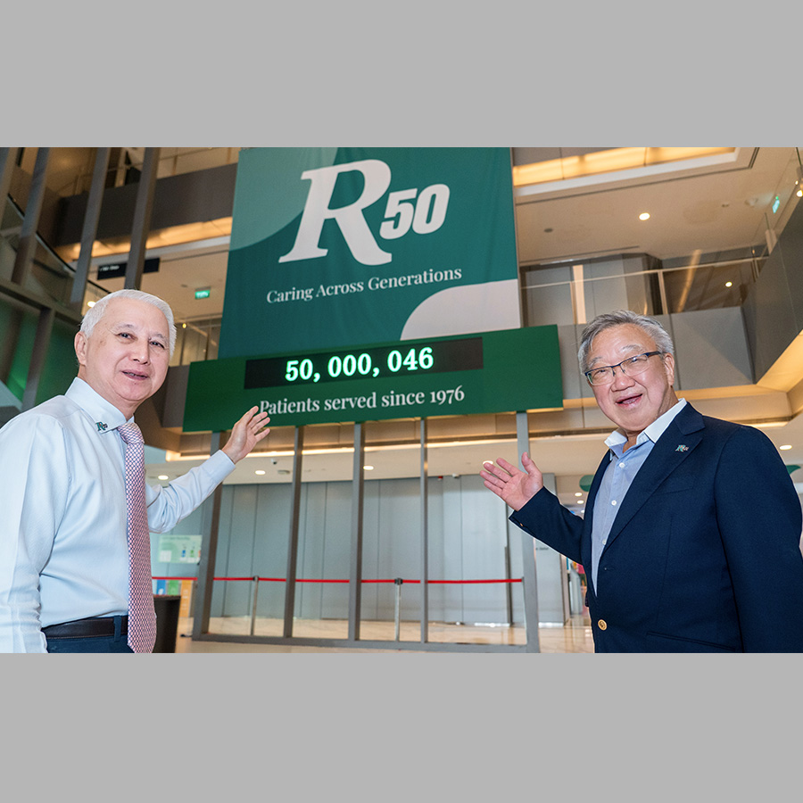 Dr Loo and Dr Loh Founders of Raffles Medical Group standing before the 50 million patient countdown milestone